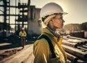Portrait of a female construction worker on the background of a construction site.
